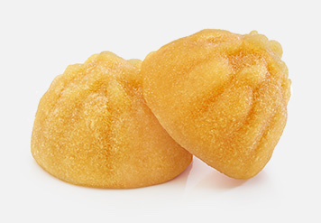 Dos gomas de fruta amarillas en forma de cúpula.