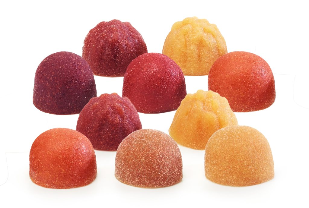 Unsere Geschäftsbereiche: Paradise Fruits Solutions & Health Fein säuberlich angeordnete Fruchtgummis in Kuppelform.