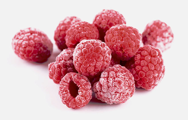 Paradise Fruits - 3 brands one family A bunch of frozen raspberries up close.
